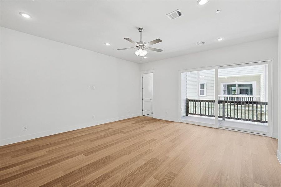 Spare room featuring light wood-type flooring, ceiling fan, and recessed lighting