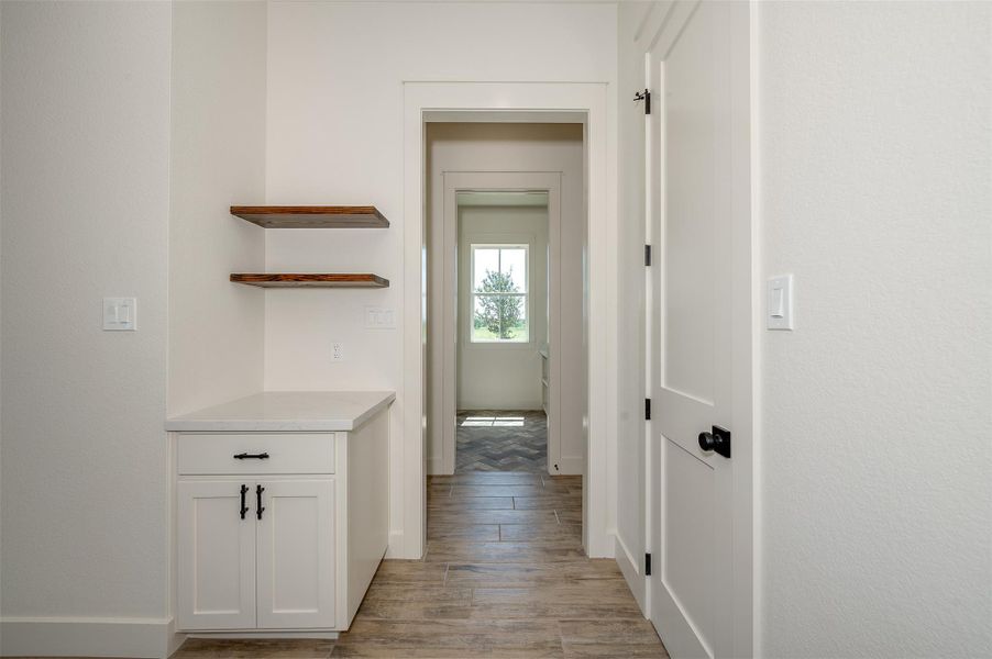 Hall with wood tiled floors and baseboards