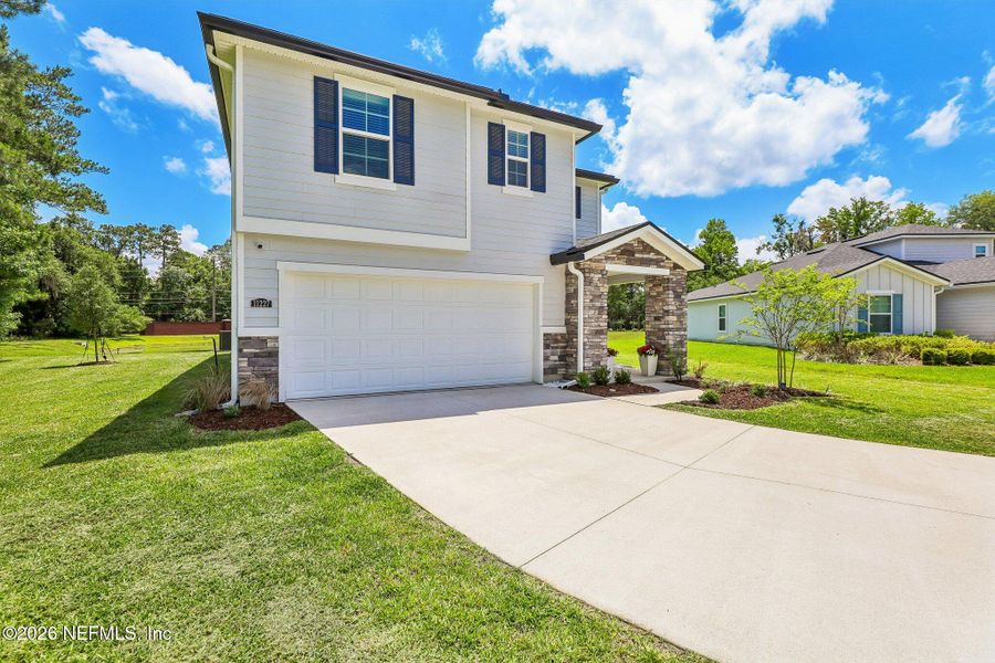 Front exterior of a new home in Dunns Crossing, Jacksonville, FL, highlighting curb appeal (Image 25). Front exterior of a new home in Dunns Crossing, Jacksonville, FL, highlighting curb appeal (Image 25).