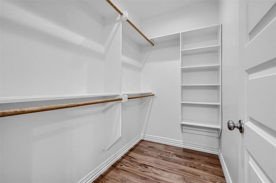 Spacious closet featuring hardwood / wood-style flooring