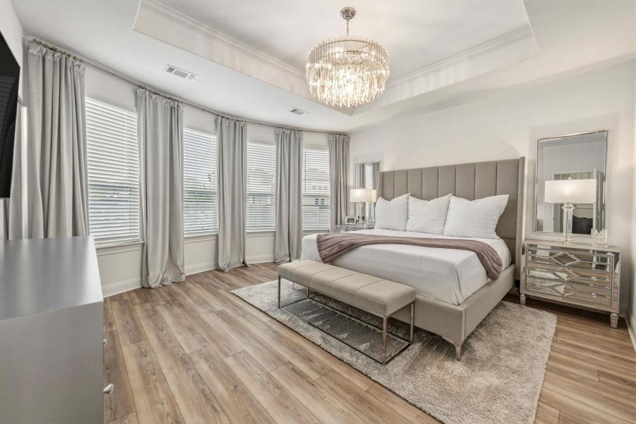 Spacious room featuring a tray ceiling