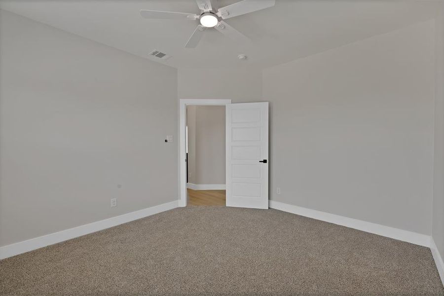 Unfurnished room with light colored carpet, ceiling fan, and baseboards Unfurnished room with light colored carpet, ceiling fan, and baseboards