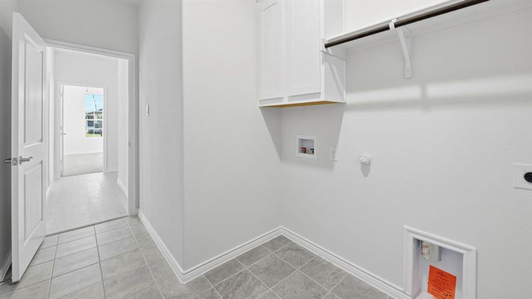 Washroom featuring gas dryer hookup, washer hookup, cabinet space, and hookup for an electric dryer