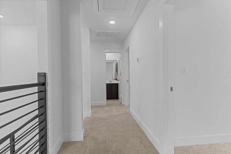 Upstairs hallway connects the secondary bedrooms and game room, with plush carpet underfoot and recessed lighting creating a bright, open feel. **Image Representative of Plan Only and May Vary as Built**.