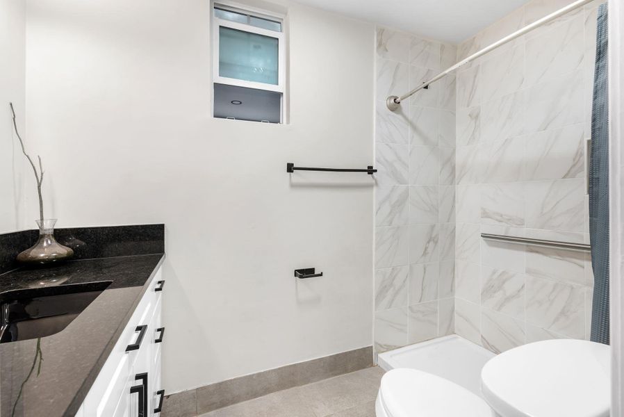 Bathroom with vanity and a stall shower