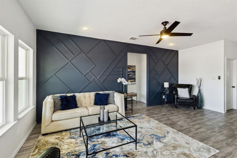 Living room with ceiling fan and wood-type flooring