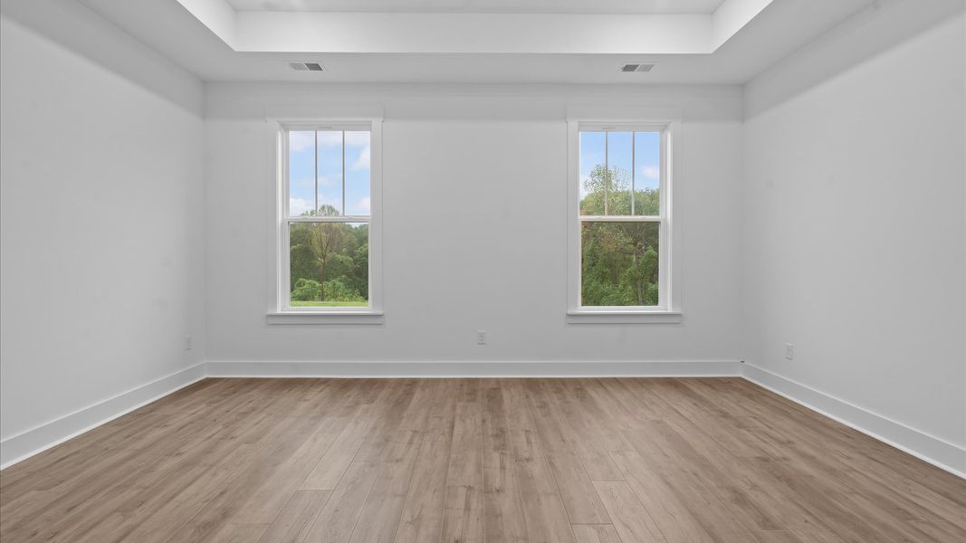 First-class hardwood floors and tasteful finishes elevate the private retreat of this exceptional primary suite