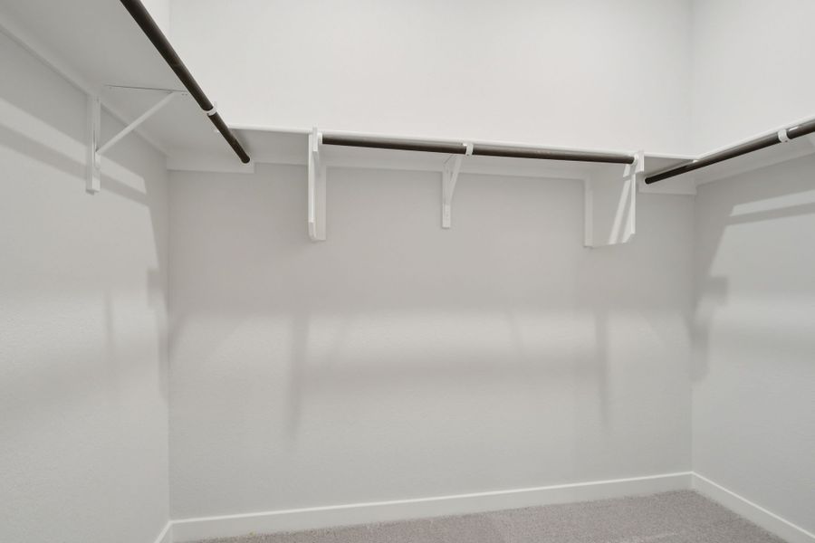 A white wall with a metal bar.