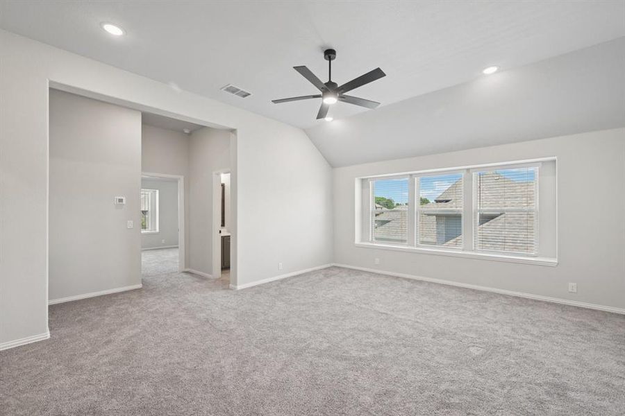 Unfurnished room with lofted ceiling, light carpet, recessed lighting, and ceiling fan Unfurnished room with lofted ceiling, light carpet, recessed lighting, and ceiling fan