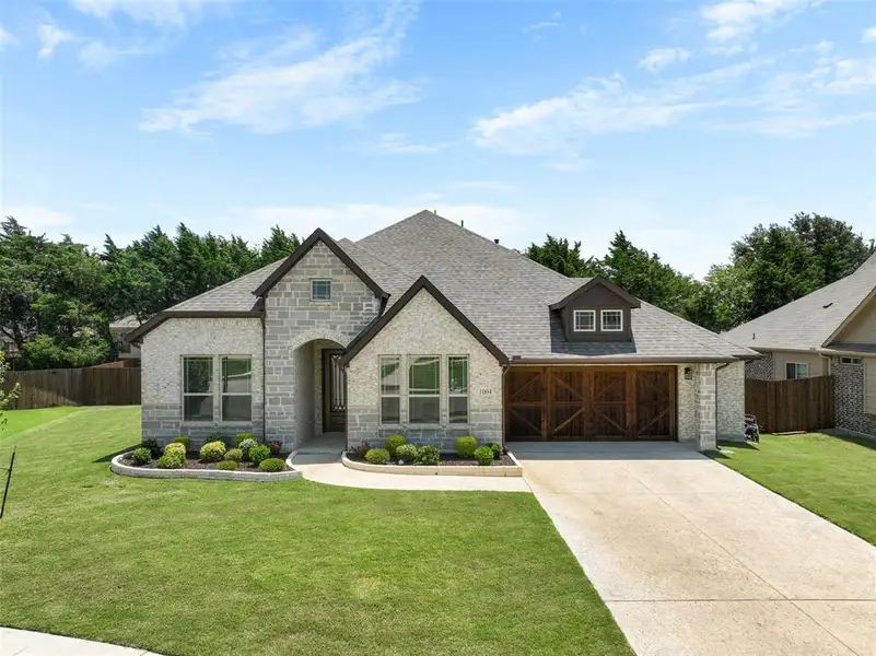 Stone and brick exterior with dark trim accents Stone and brick exterior with dark trim accents