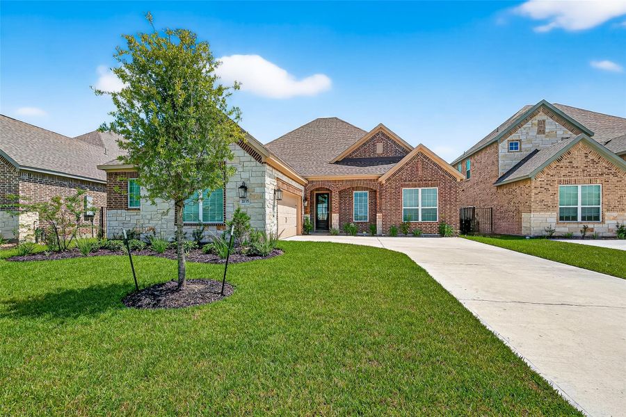 Front exterior of a new home in Sierra Vista, Iowa Colony, TX, highlighting curb appeal (Image 25). Front exterior of a new home in Sierra Vista, Iowa Colony, TX, highlighting curb appeal (Image 25).