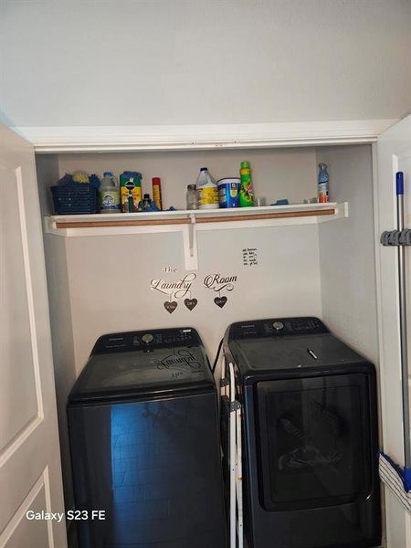Laundry room with washer and clothes dryer