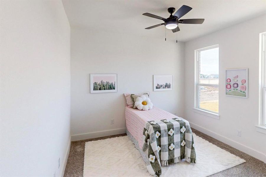 Carpeted bedroom with ceiling fan