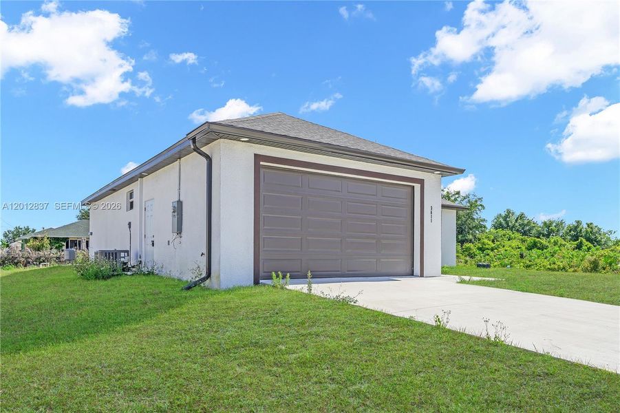 Front exterior of a new home in , Lehigh Acres, FL, highlighting curb appeal (Image 16).