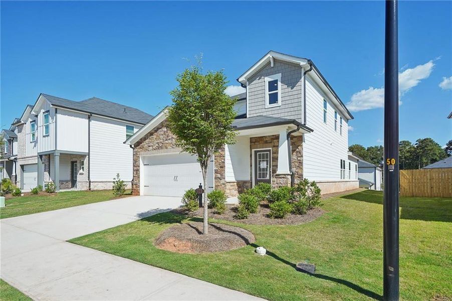 Front exterior of a new home in Martin Springs - Reserve Series, Lawrenceville, GA, highlighting curb appeal (Image 2). Front exterior of a new home in Martin Springs - Reserve Series, Lawrenceville, GA, highlighting curb appeal (Image 2).