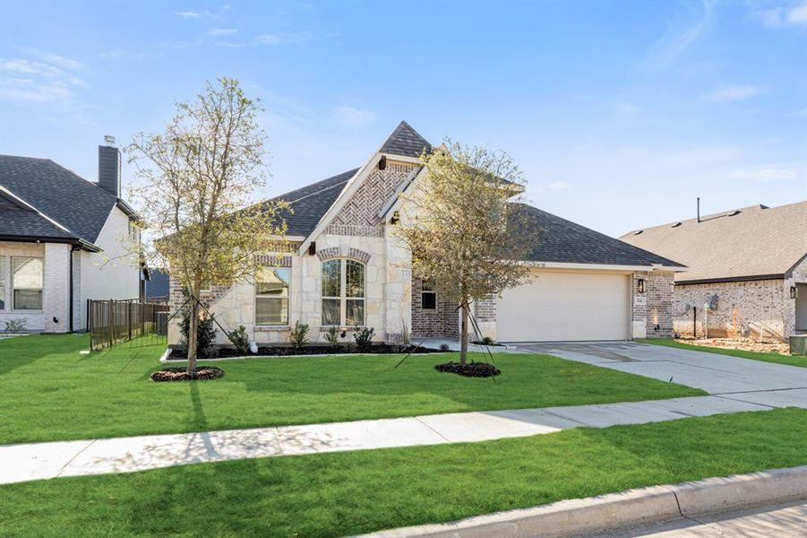 Front exterior of a new home in Abe's Landing, Granbury, TX, highlighting curb appeal (Image 18). Front exterior of a new home in Abe's Landing, Granbury, TX, highlighting curb appeal (Image 18).