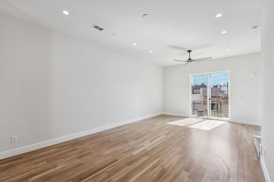 Spacious Living area with Visual comfort ceiling fan, speaker wire and balcony