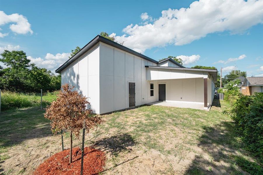 Back of house featuring a patio, board and batten siding, and a lawn Back of house featuring a patio, board and batten siding, and a lawn