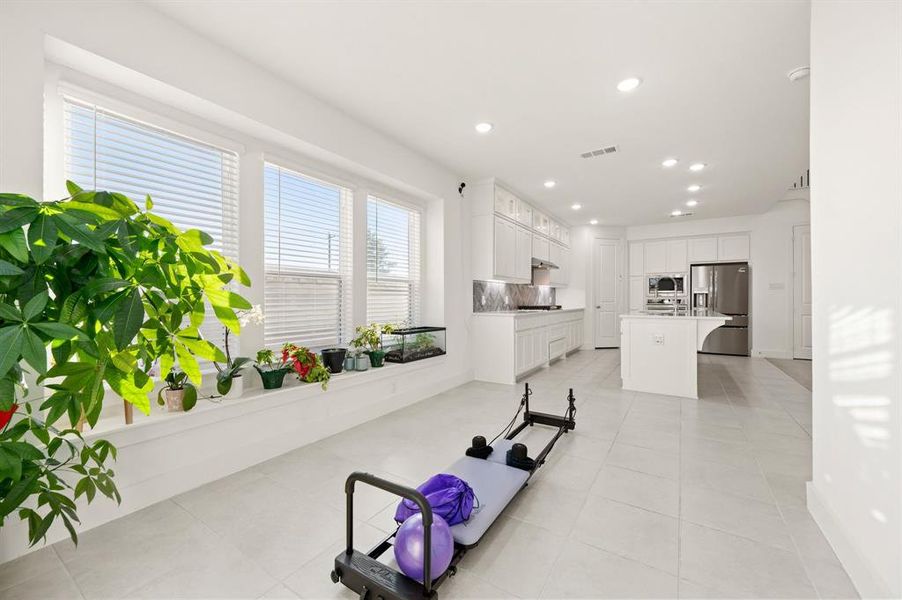 Workout area featuring recessed lighting and light tile patterned floors