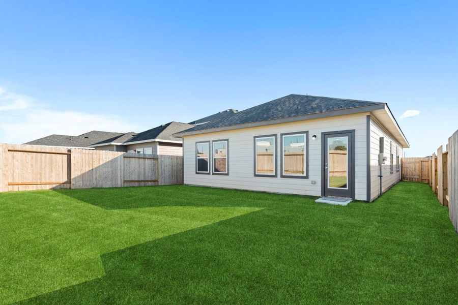 Rear view of the home highlighting its clean lines, durable exterior finishes, and large windows that fill the interior with natural light—designed for comfort and low maintenance. Rear view of the home highlighting its clean lines, durable exterior finishes, and large windows that fill the interior with natural light—designed for comfort and low maintenance.