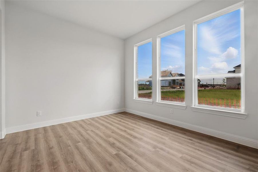 Unfurnished room with baseboards and wood finished floors Unfurnished room with baseboards and wood finished floors