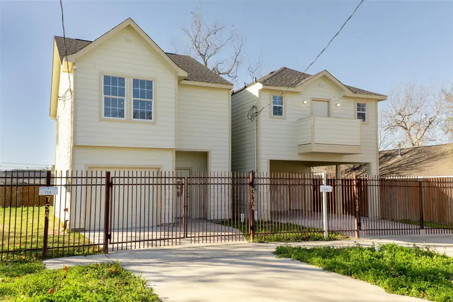 This photo showcases the backyard of a two-story house with light-colored siding. The yard is spacious with grass and a few trees, enclosed by a wooden fence, offering privacy and ample outdoor space. This photo showcases the backyard of a two-story house with light-colored siding. The yard is spacious with grass and a few trees, enclosed by a wooden fence, offering privacy and ample outdoor space.