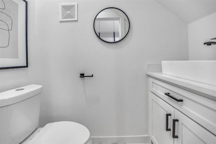 Bathroom with vanity and a textured wall Bathroom with vanity and a textured wall