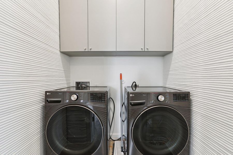 Laundry area with cabinet space and washing machine and dryer
