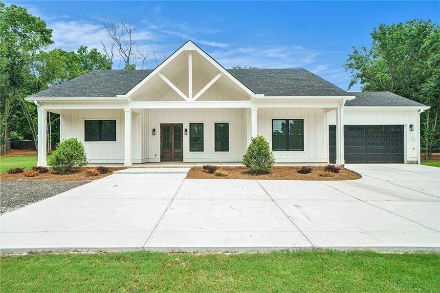 Front exterior of a new home in , Conyers, GA, highlighting curb appeal (Image 1). Front exterior of a new home in , Conyers, GA, highlighting curb appeal (Image 1).