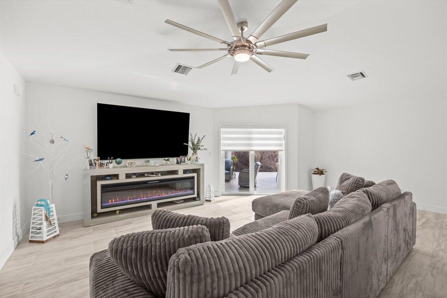 Expansive Family Room Featuring Motorized Privacy Shades and Seamless Backyard Views