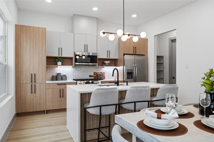 A chef-inspired kitchen designed for both beauty and function—quartz countertops, soft-close cabinetry, designer lighting, and a sleek gas range invite you to cook, gather, and make memories in a space that truly feels like home.