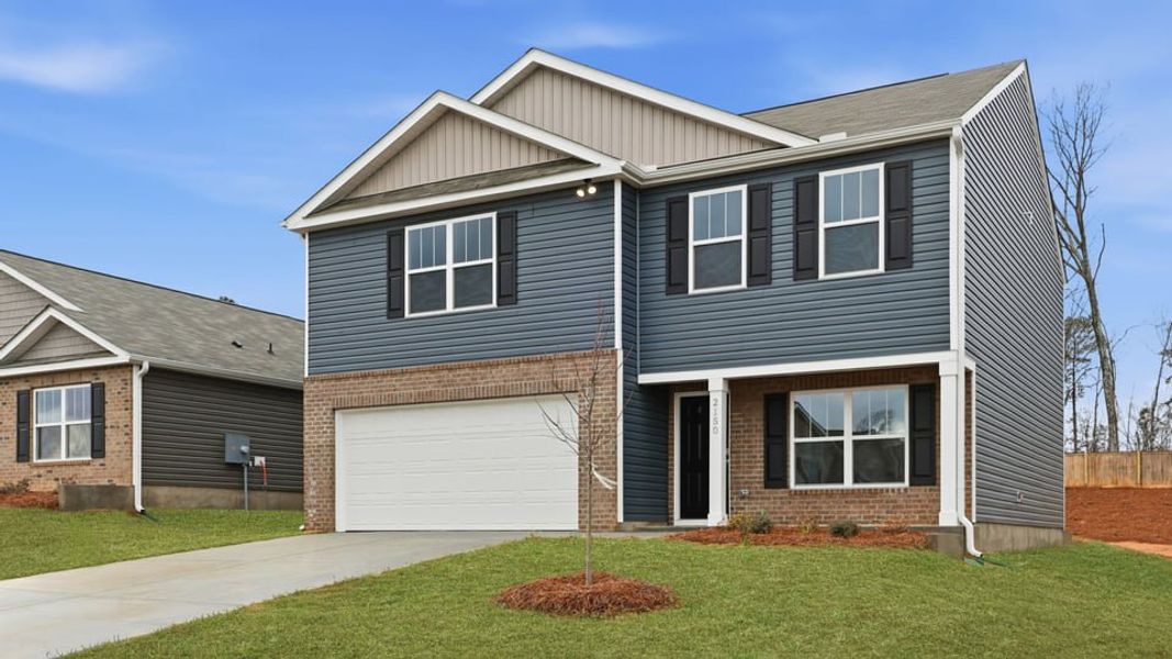 Front exterior of a new home in Harrier Point, Woodruff, SC, highlighting curb appeal (Image 2). Front exterior of a new home in Harrier Point, Woodruff, SC, highlighting curb appeal (Image 2).