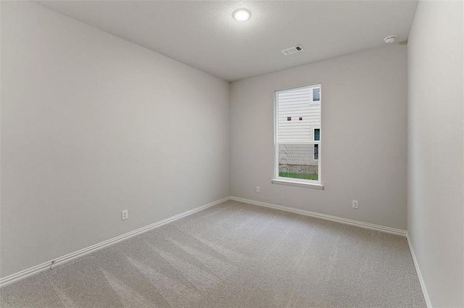 Carpeted room with a single window, recessed lighting, and light-colored walls