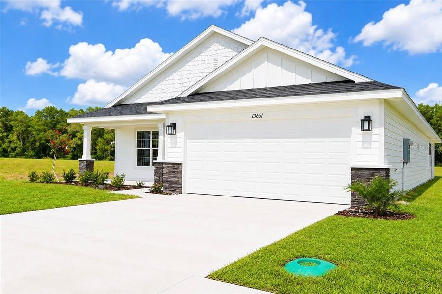 Front exterior of a new home in Kirkland Farms, Alachua, FL, highlighting curb appeal (Image 2). Front exterior of a new home in Kirkland Farms, Alachua, FL, highlighting curb appeal (Image 2).