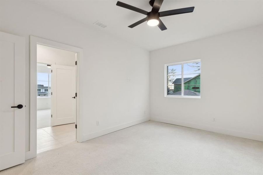 Unfurnished room with light colored carpet and ceiling fan