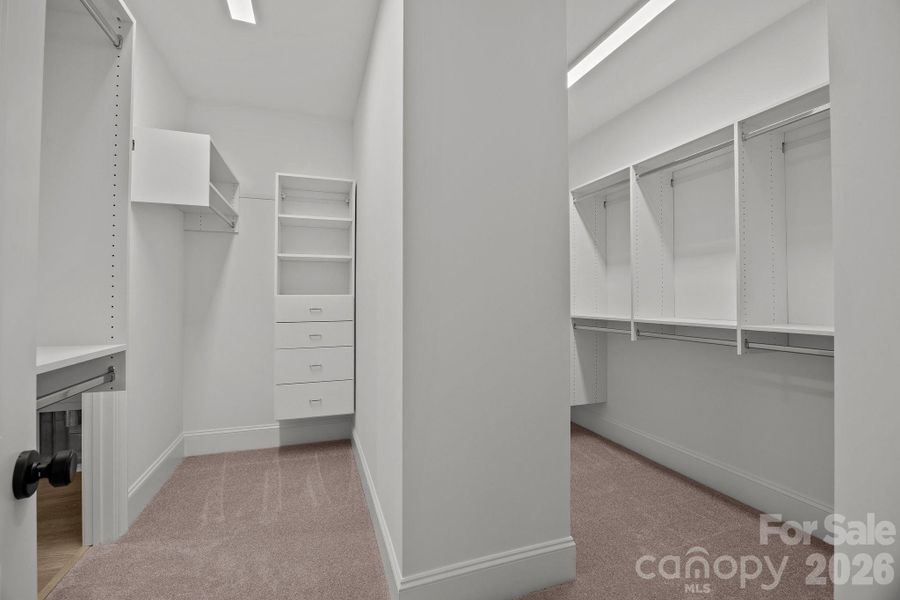 Spacious closet with access to laundry room