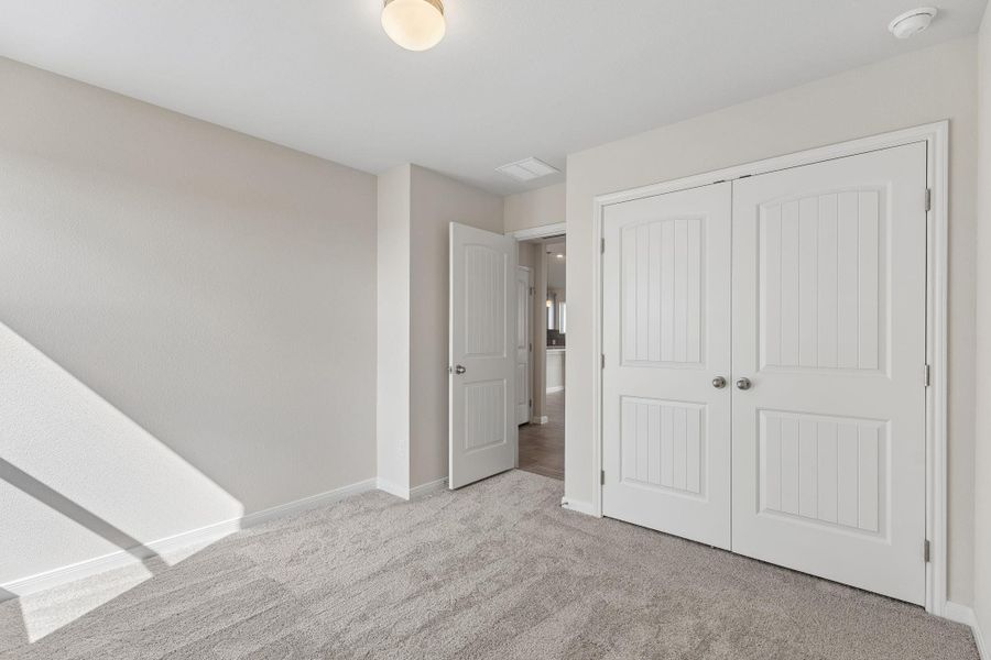 Versatile room detailed with classic paneled closet doors.