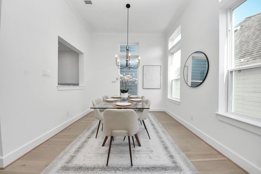 Welcome to this bright, modern dining room, featuring a sleek glass table with seating for six under a contemporary chandelier. Large windows fill the space with natural light, while the neutral color palette and minimalist decor create an inviting atmosphere perfect for meals and gatherings. Welcome to this bright, modern dining room, featuring a sleek glass table with seating for six under a contemporary chandelier. Large windows fill the space with natural light, while the neutral color palette and minimalist decor create an inviting atmosphere perfect for meals and gatherings.