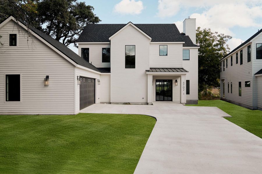 View of front facade with concrete driveway, a shingled roof, a front lawn, and an attached garage View of front facade with concrete driveway, a shingled roof, a front lawn, and an attached garage