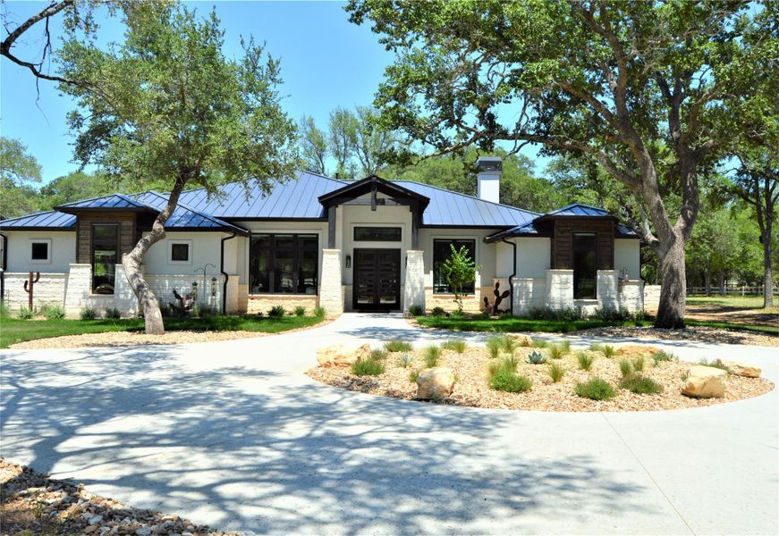 View of front of property featuring a standing seam metal roof, and stone, stucco View of front of property featuring a standing seam metal roof, and stone, stucco