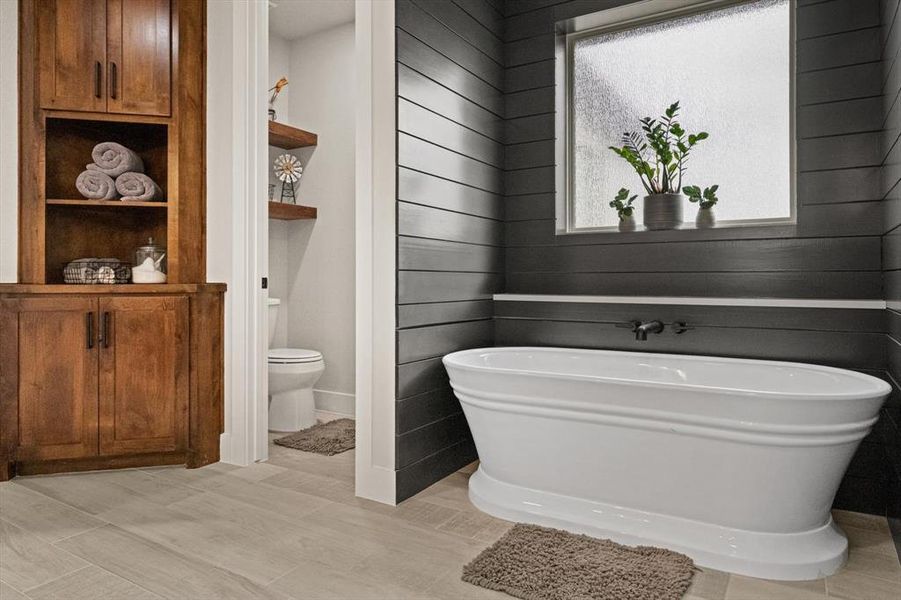 Luxurious soaking tub, separate shower and private water closet.