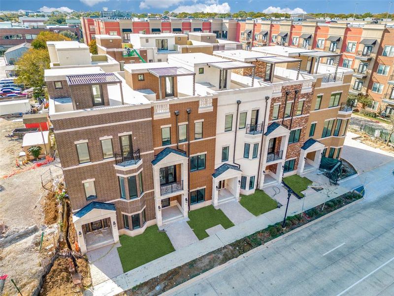 Welcome to The Grapevine Brownstones! These homes are currently under construction and green grass is a representation of future completed landscaping.