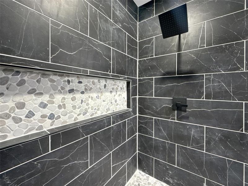 Full bath featuring a tile shower