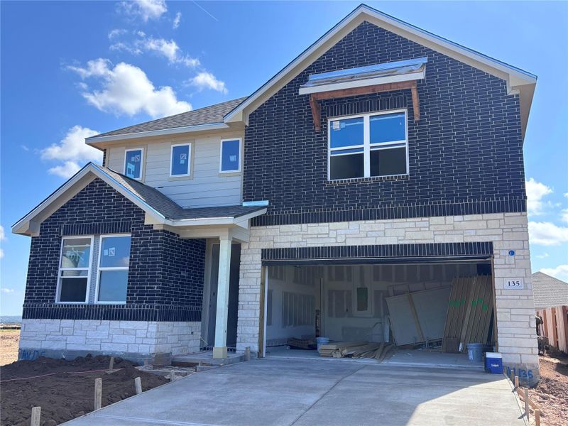Front exterior of a new home in The Colony 45s, Bastrop, TX, highlighting curb appeal (Image 1).