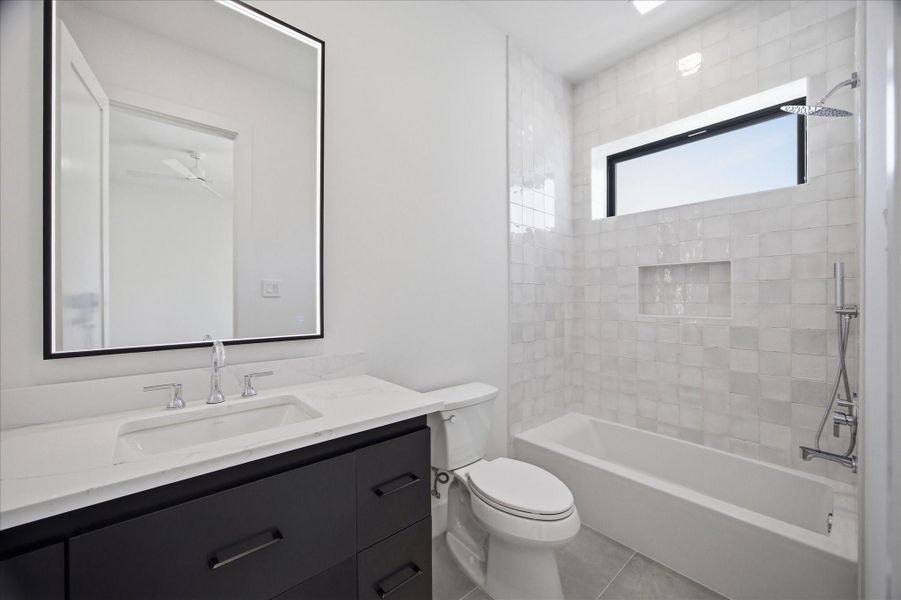 Contemporary vanities with sleek hardware and illuminated mirrors add both function and sophistication.