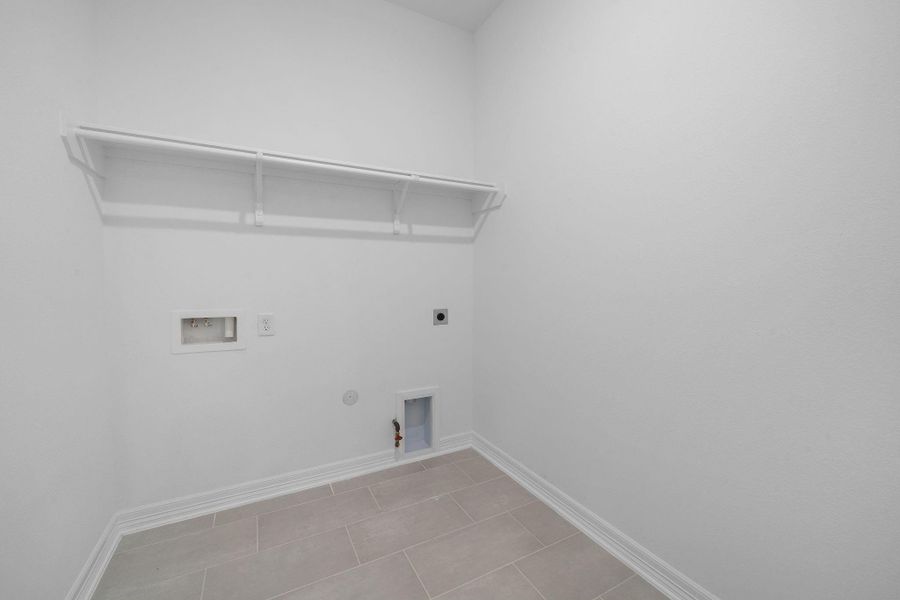 The laundry room layout is carefully planned for optimal workflow with designated areas for washing, drying, and storing. The laundry room layout is carefully planned for optimal workflow with designated areas for washing, drying, and storing.