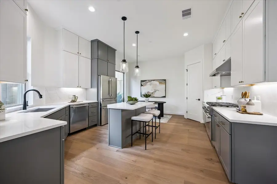 This stunning open-concept gourmet kitchen is perfect for entertaining, featuring top-tier Thermador appliances, including a professional six-burner stove. A center island offers dining and prep space, while a large picture window bathes the space in natural light.