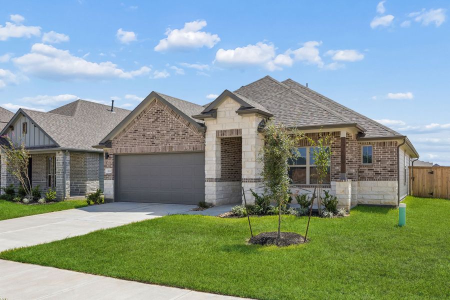 Front exterior of a new home in Riviera Pines, Huffman, TX, highlighting curb appeal (Image 2). Front exterior of a new home in Riviera Pines, Huffman, TX, highlighting curb appeal (Image 2).
