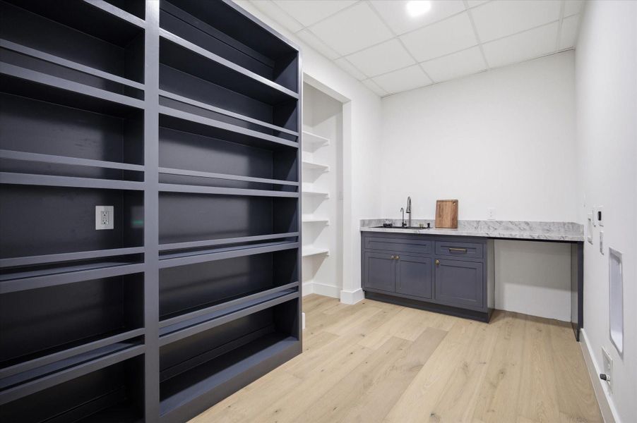 A discreet extension of the kitchen, offering additional prep space and storage while maintaining the home’s cohesive, elevated design.