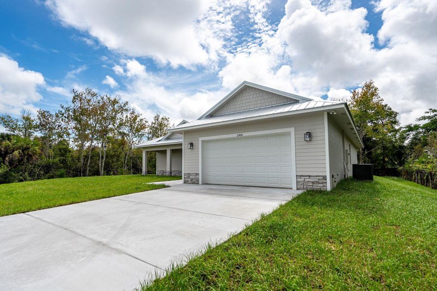 Front exterior of a new home in , Fort Pierce, FL, highlighting curb appeal (Image 1).